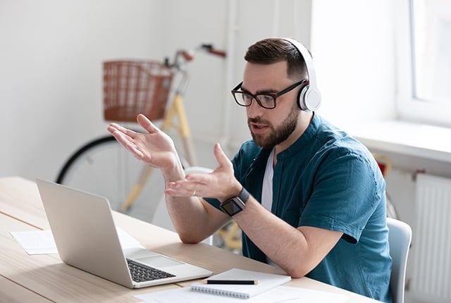 Man in front of laptop explaining on call
