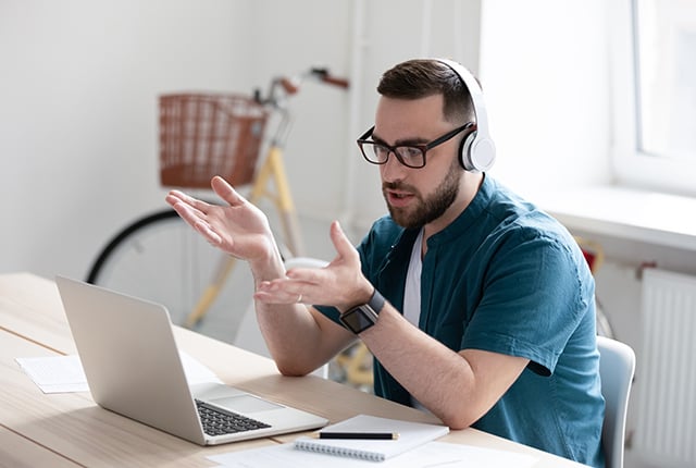 Focused young businessman holding video call with clients