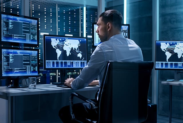 Technical Controller Working at His Workstation with Multiple Displays