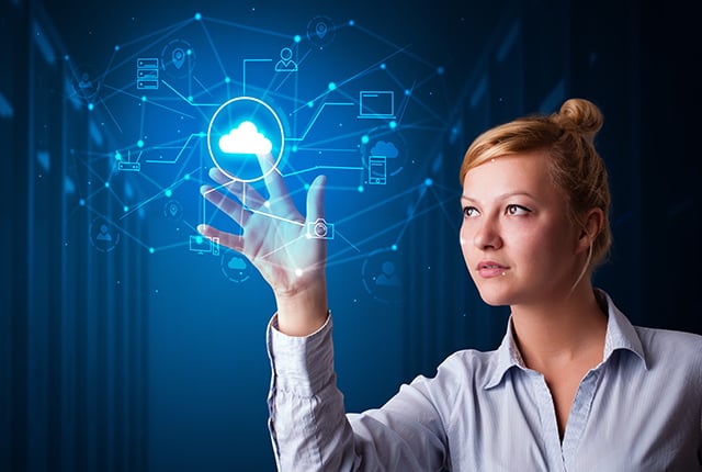 Woman touching hologram projection displaying cloud system