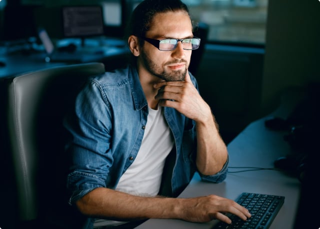 man-with-glasses-looking-at-laptop man with glasses looking at laptop