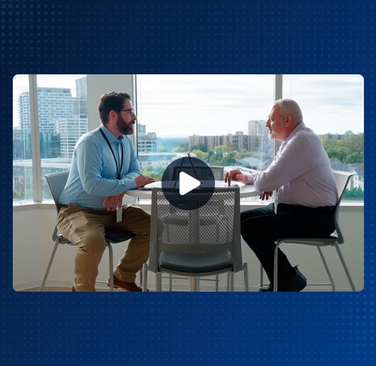 Two men sitting at table conversing