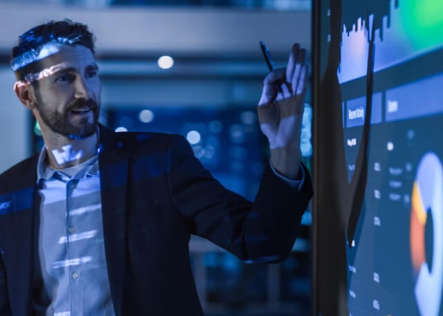 Man wearing suit showing charts